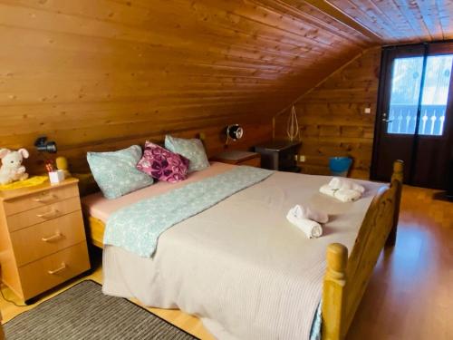 a bedroom with a large bed with towels on it at Countryside riverside cabin for both winter and summer for max 15 persons in Janakkala