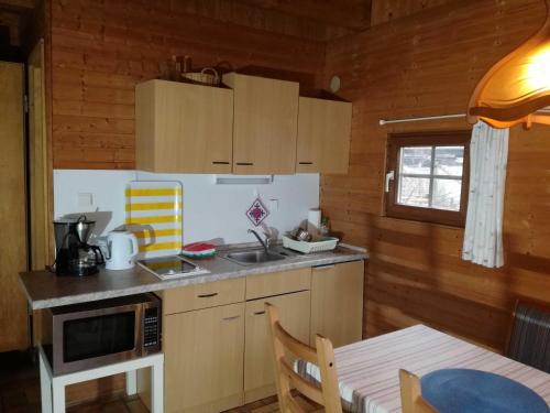 a small kitchen with a sink and a stove at Ferienhaus Suda in Timmendorfer Strand