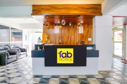 a lobby of a hotel with a ibid huts sign at FabHotel Omkar Executive in Pune