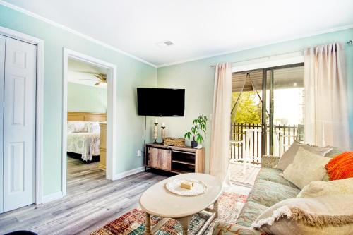 a living room with a couch and a tv at North Myrtle Hideaway in Myrtle Beach