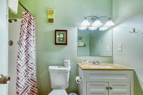 a bathroom with a toilet and a sink and a mirror at North Myrtle Hideaway in Myrtle Beach