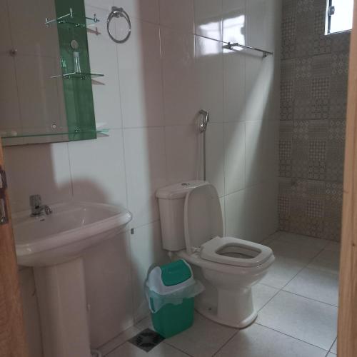 a bathroom with a toilet and a sink at Hospedaje por día.. in Encarnación