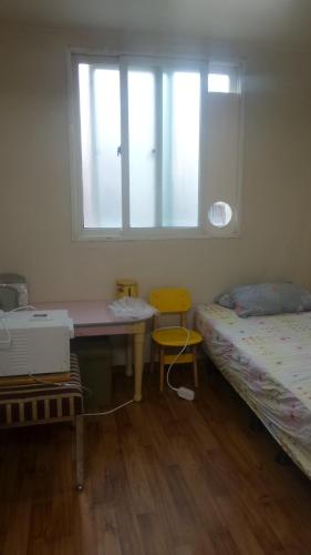 Postel nebo postele na pokoji v ubytování Ocean House Suwon