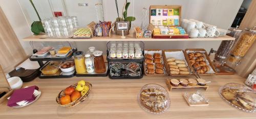 a table topped with lots of different types of food at Kyriad Direct Arpajon in Arpajon