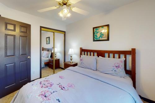 a bedroom with a bed and a ceiling fan at Hideaway Harbor in Holiday Island