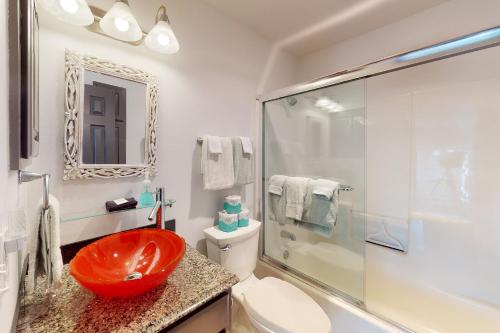 a bathroom with a red sink and a shower at Hideaway Harbor in Holiday Island