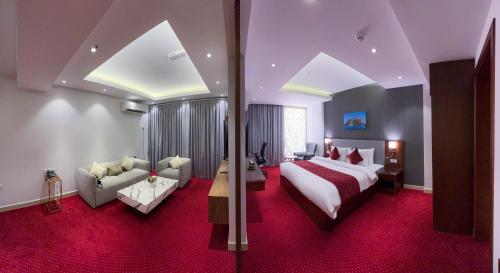 Muscat Express Hotel في مسقط: غرفه فندقيه بسرير واريكه