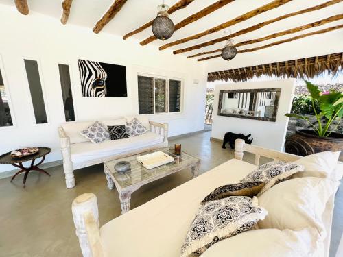 a living room with a couch and a table at Beba.Beach.House in Watamu