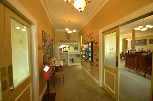 a hallway of a store with a counter and a room at The Prince Albert Backpackers & Bar in Nelson