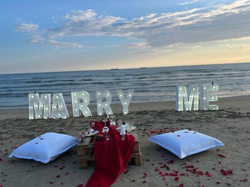 a table on the beach with a marry me sign at Adriatik Hotel, BW Premier Collection in Durrës