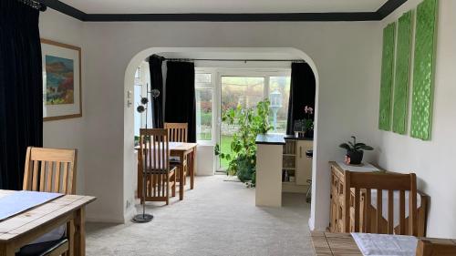 a kitchen and dining room with a table and chairs at Ramsey House - Luxury Licensed B&B - Parking and Guest Lounge in St. Davids