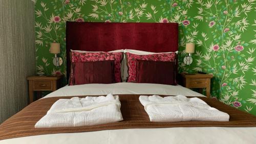 a bed with two white towels on top of it at Ramsey House - Luxury Licensed B&B - Parking and Guest Lounge in St. Davids