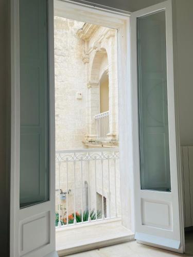 a view through a door into a building at Dimora a Palazzo in Monopoli