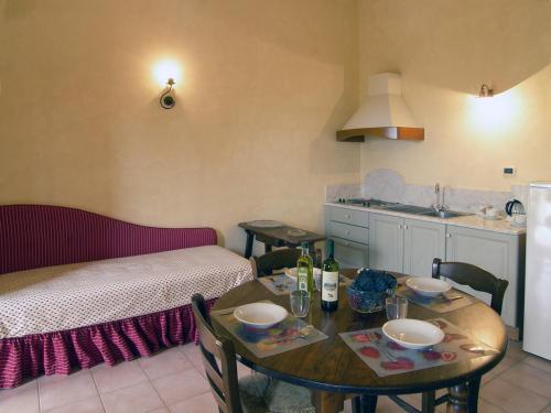 ein Wohnzimmer mit einem Tisch und einer Küche in der Unterkunft Appartamento Isabella in San Miniato