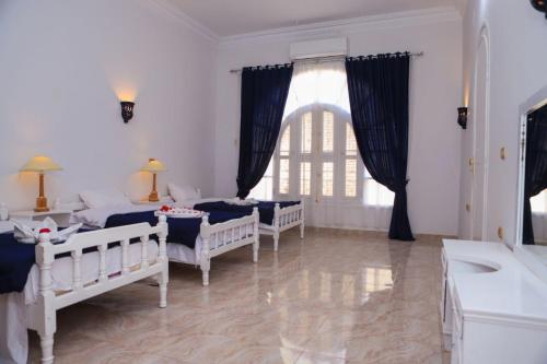 Ένα ή περισσότερα κρεβάτια σε δωμάτιο στο Luxor Oasis Guest House
