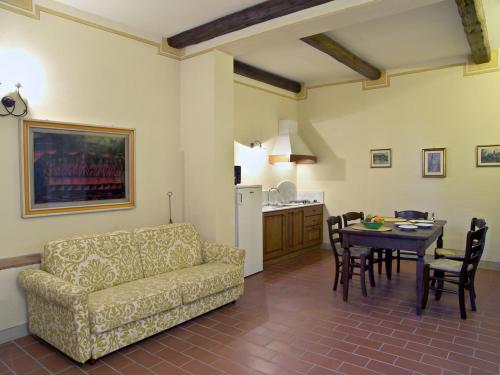 a living room with a couch and a table at Appartamento Frantoio in San Miniato