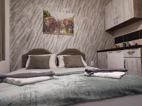 a bedroom with a large bed with two pillows at Apartments Blago Sutomore in Sutomore