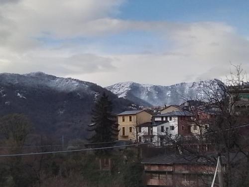a group of houses in front of a mountain at ANITA B&B in Uscio