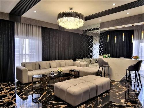 a living room with a couch and a table at Majestic City Retreat Hotel in Dubai