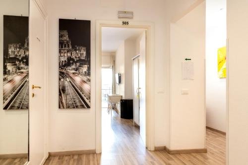 a hallway with a white door and a painting on the wall at Aurelia Home Guest House in Rome
