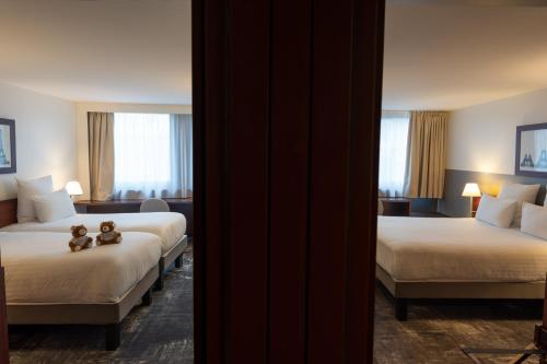 Ένα ή περισσότερα κρεβάτια σε δωμάτιο στο Mercure Paris Gare Montparnasse TGV