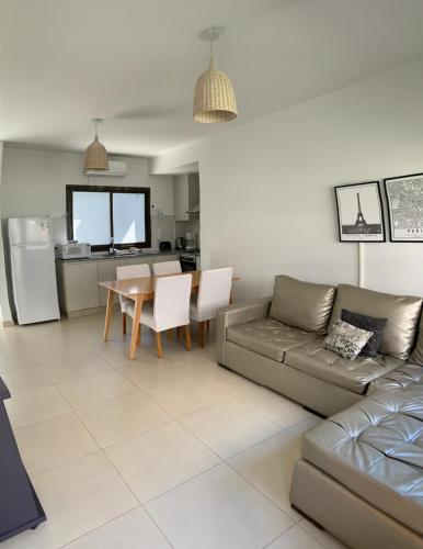 a living room with a couch and a table at Moreno Park Complejo Residencial 1 in Ciudad Lujan de Cuyo