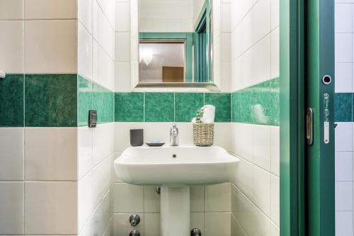 a bathroom with a sink and a mirror at BePlace Apartments in Dateo in Milan