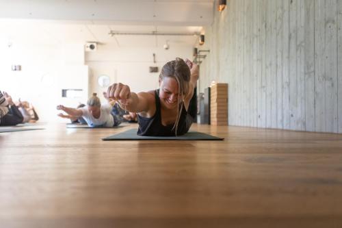 a woman doing a yoga pose on the floor at Das Kubatzki in Sankt Peter-Ording