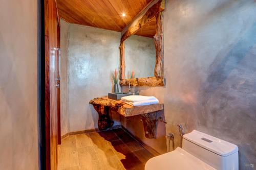 a bathroom with a sink and a toilet at Chocolate Hotel in Itacaré