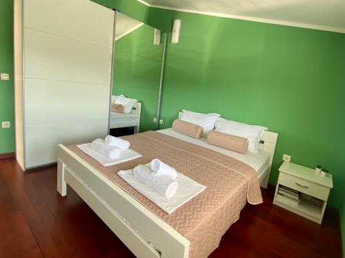 a bedroom with a bed with two towels on it at Villa Visualizza in Čapljina