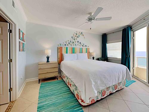 a bedroom with a large bed and a window at The Enclave #705 in Orange Beach