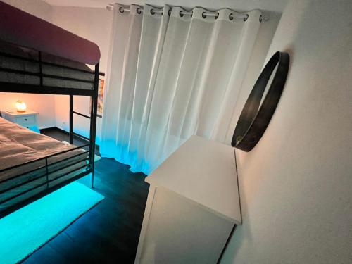 a room with a bed and a desk in a room at Casa Ucliva - Charming Alpine Apartment Getaway in the Heart of the Swiss Alps in Rueras