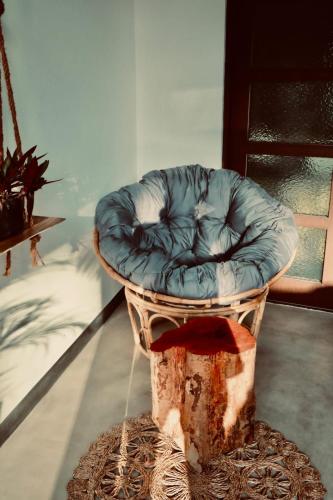 a blue chair sitting in the middle of a room at The Jini House in Ahangama