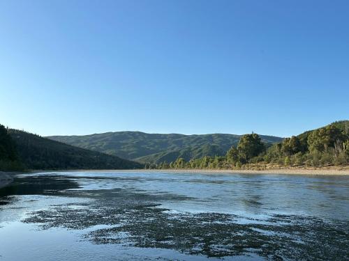 a view of a river with mountains in the background at Forel in Toconey