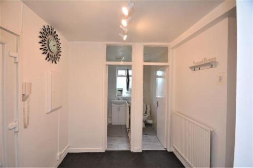 a hallway with a hallway leading to a bathroom at London zone2 Classic 3 bedroom in London