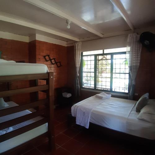 Una cama o camas en una habitación de Finca La Perla Yopal