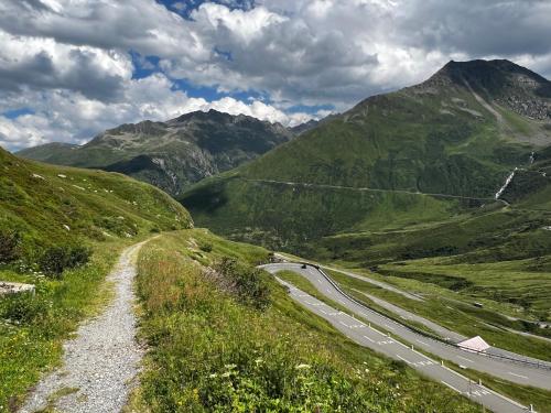 a winding road on the side of a mountain at Casa Ucliva - Charming Alpine Apartment Getaway in the Heart of the Swiss Alps in Rueras