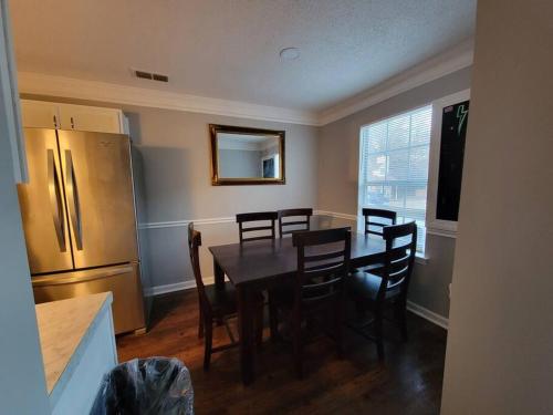 a kitchen with a table with chairs and a refrigerator at Perfect Place for Families in Hernando