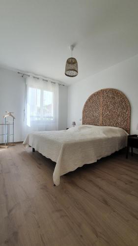 a bedroom with a large bed in a white room at T2 NEUF ANGLET CENTRE - BIARRITZ in Anglet