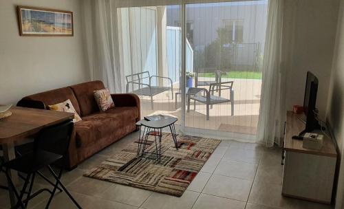 a living room with a couch and a table at T2 NEUF ANGLET CENTRE - BIARRITZ in Anglet