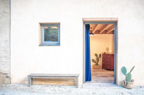 a door to a room with a bench and a cactus at Eco lodge Carbonaccio in Chiatra