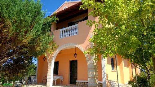 a house with an archway in front of it at ARISTIDIS APARTM. 2 in Kavos