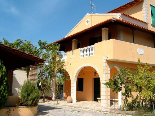 a house with an archway in front of it at ARISTIDIS APARTM. 2 in Kavos