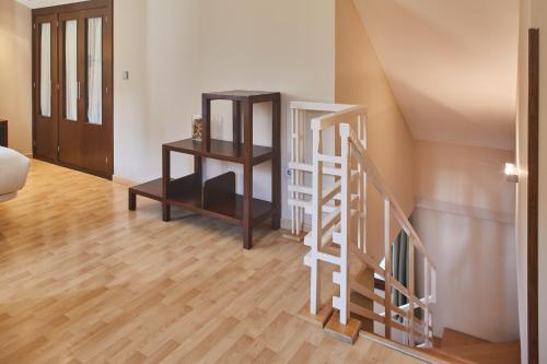 a living room with a staircase and a stair case at Silken Ordesa in Torla