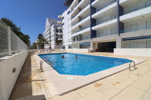 an image of a swimming pool in an apartment building at Quarteira Beach in Quarteira