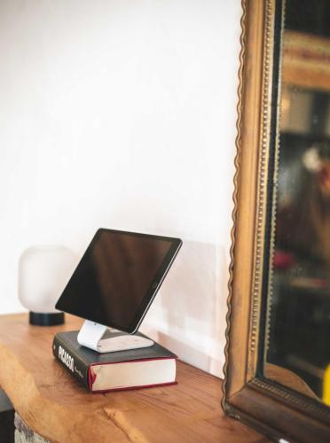 a laptop computer sitting on top of books on a table at Eco lodge Carbonaccio in Chiatra
