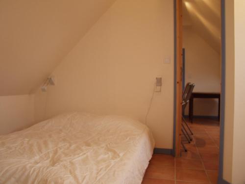a bedroom with a white bed and a chair at Appartement Le Palais, 2 pièces, 2 personnes - FR-1-418-165 in Le Palais
