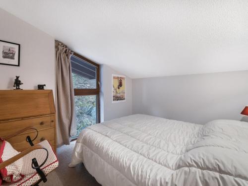 a bedroom with a bed and a dresser and a window at Appartement Megève, 3 pièces, 5 personnes - FR-1-453-145 in Megève