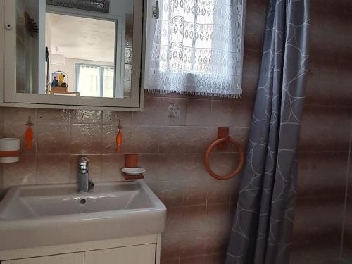 a bathroom with a sink and a shower curtain at Appartement Le Palais, 2 pièces, 3 personnes - FR-1-418-171 in Le Palais