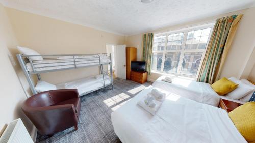 a hotel room with a bed and a bunk bed at Marine Lodge in Great Yarmouth